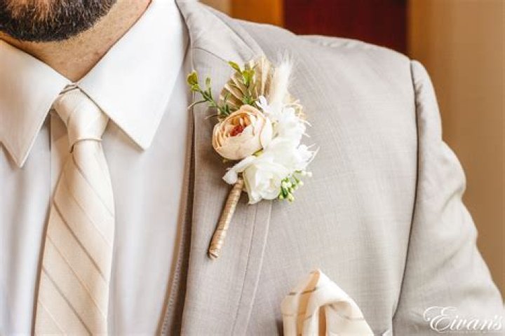 Who put boutonniere on groomsmen?