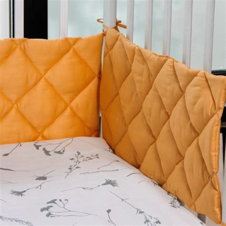 Why are cot bumpers dangerous?