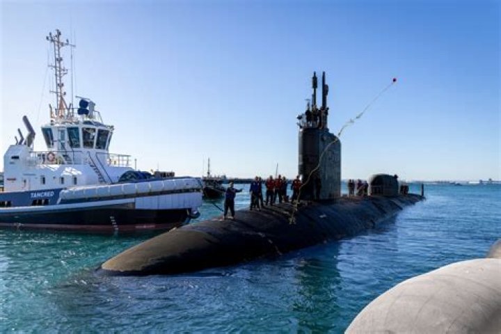 Why do submariners carry a coin?
